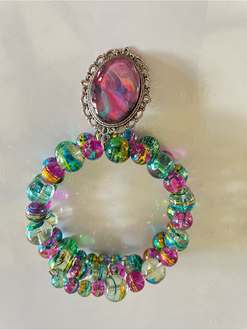 Multicolor Beaded Memory Wire Bracelet with a hand painted Pink Swirl Cabochon